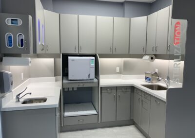Sterilization area at Avatar Dental with white countertops, cabinetry, sinks, and sterilization equipment organized in a clean, well-lit space